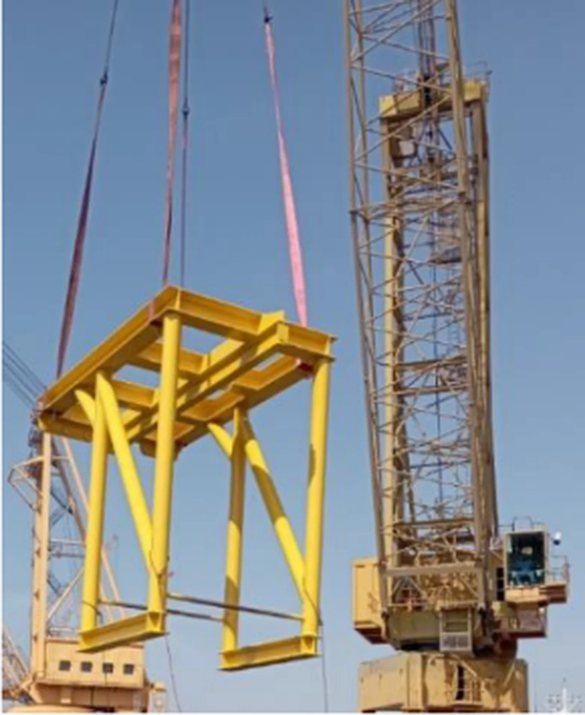 A fabricated offshore steel frame lifted by a crane
